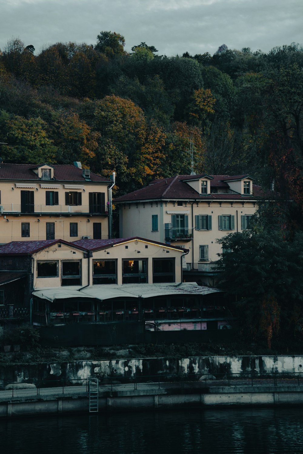 a large white building sitting on top of a lush green hillside