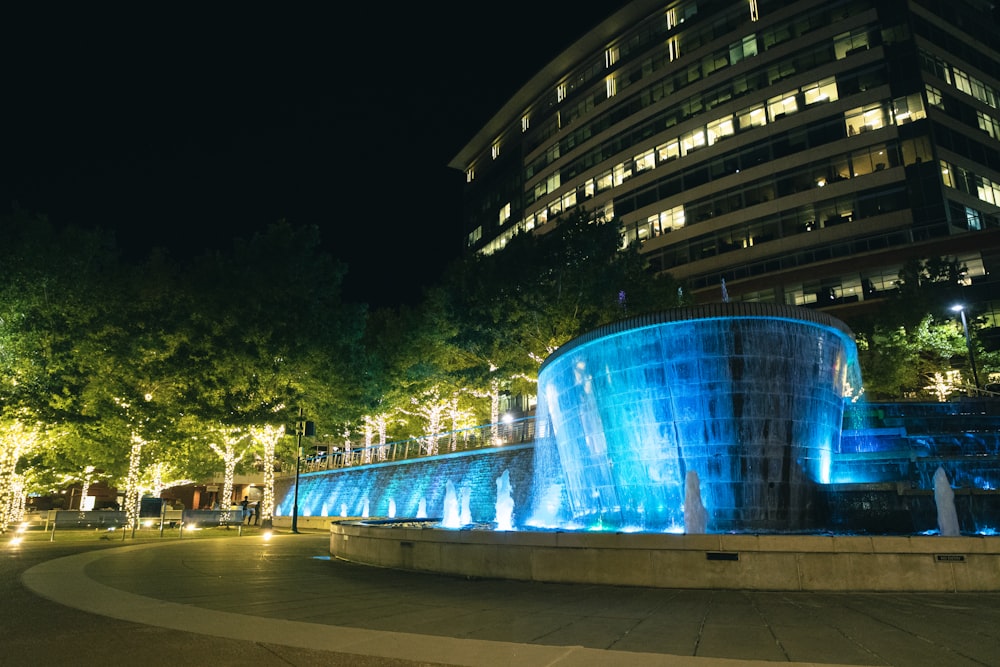 a large building with a fountain in the middle of it