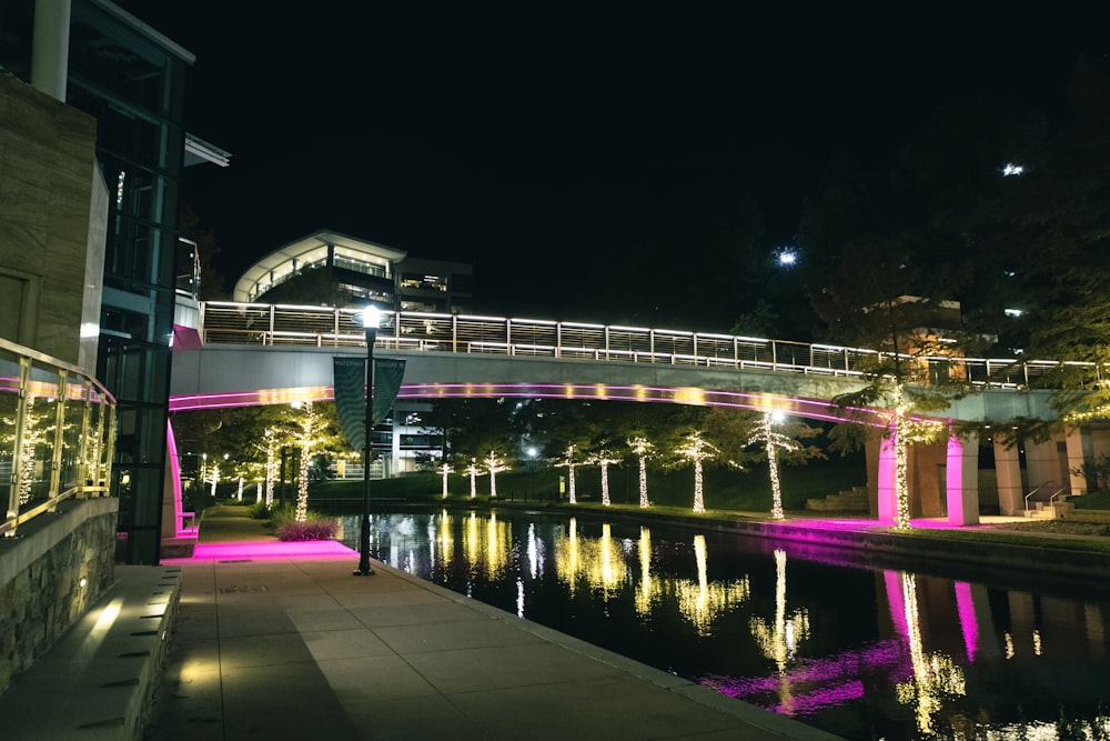 a bridge that has lights on it over a body of water