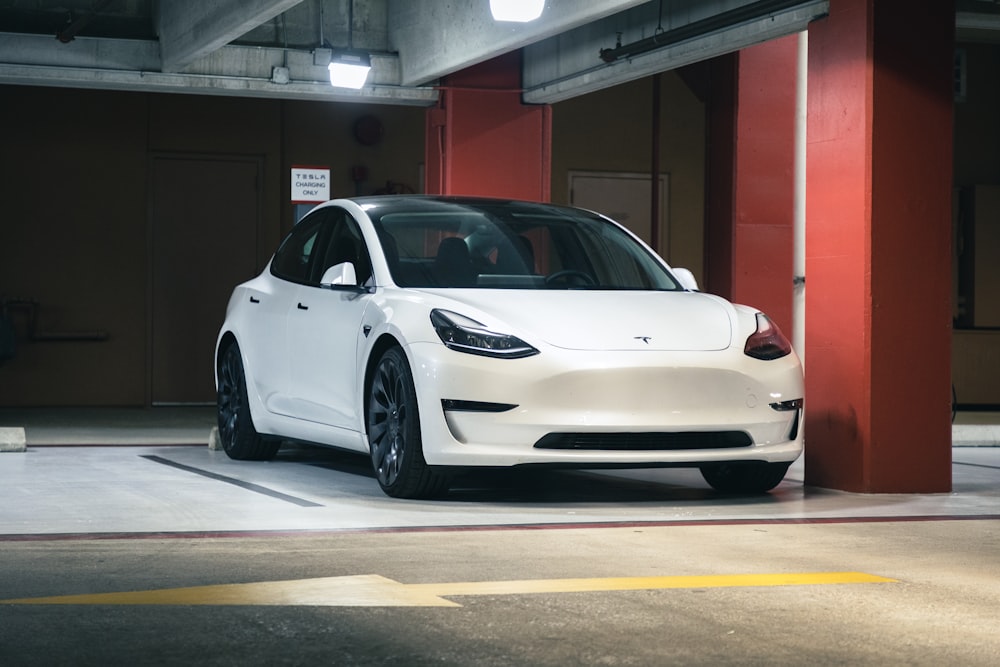 a white car parked in a parking garage