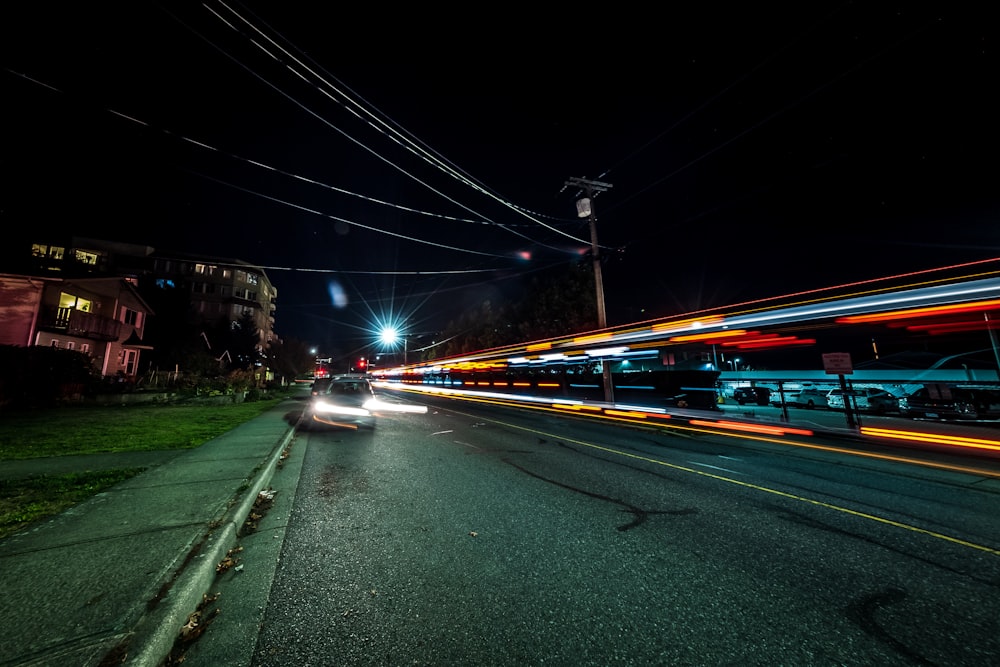 a car driving down a street at night