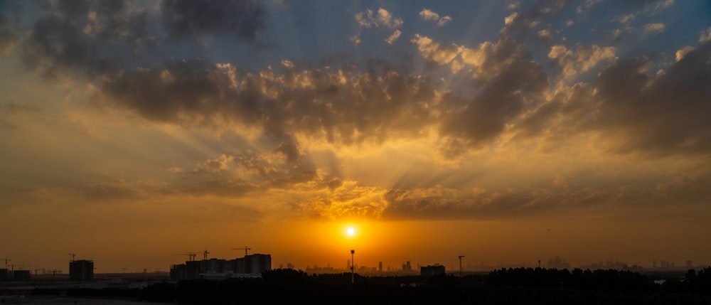 the sun is setting over a city skyline