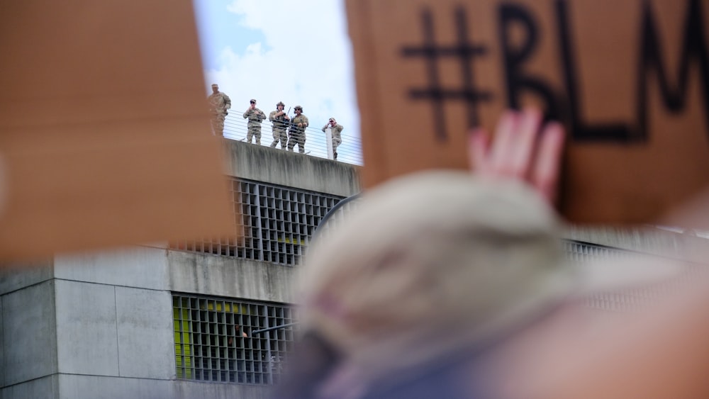 a group of people standing on top of a building