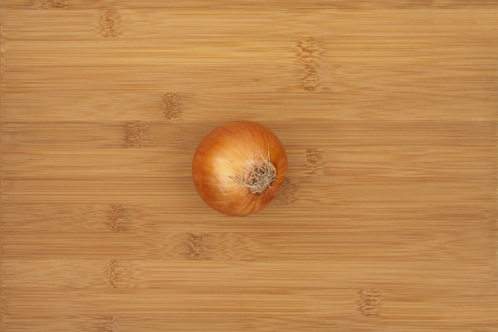 an onion on a cutting board with a knife