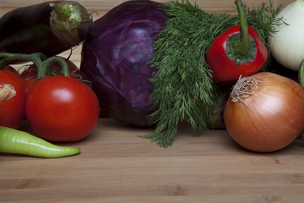 a group of vegetables sitting on top of a wooden table