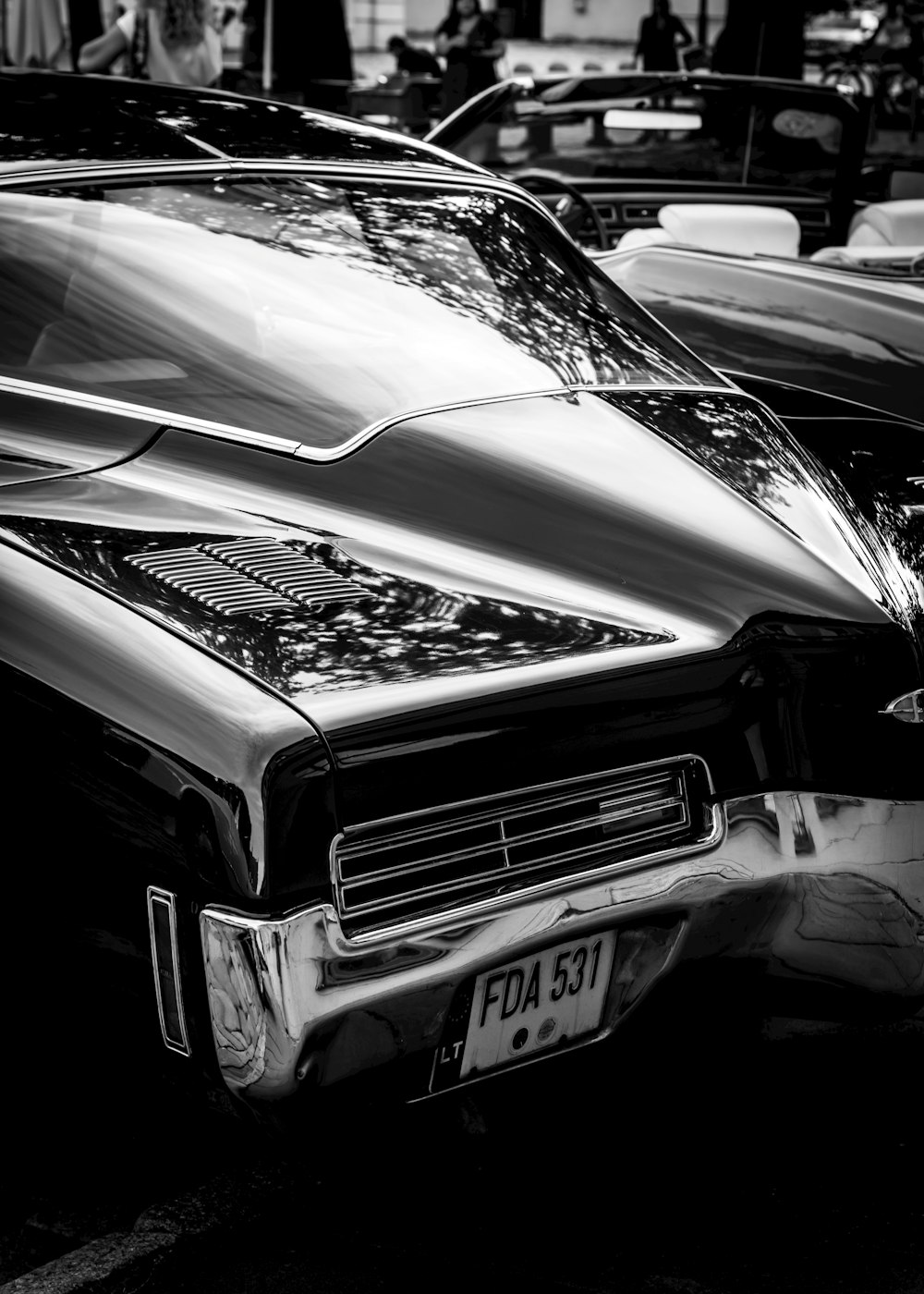 a black and white photo of a classic car