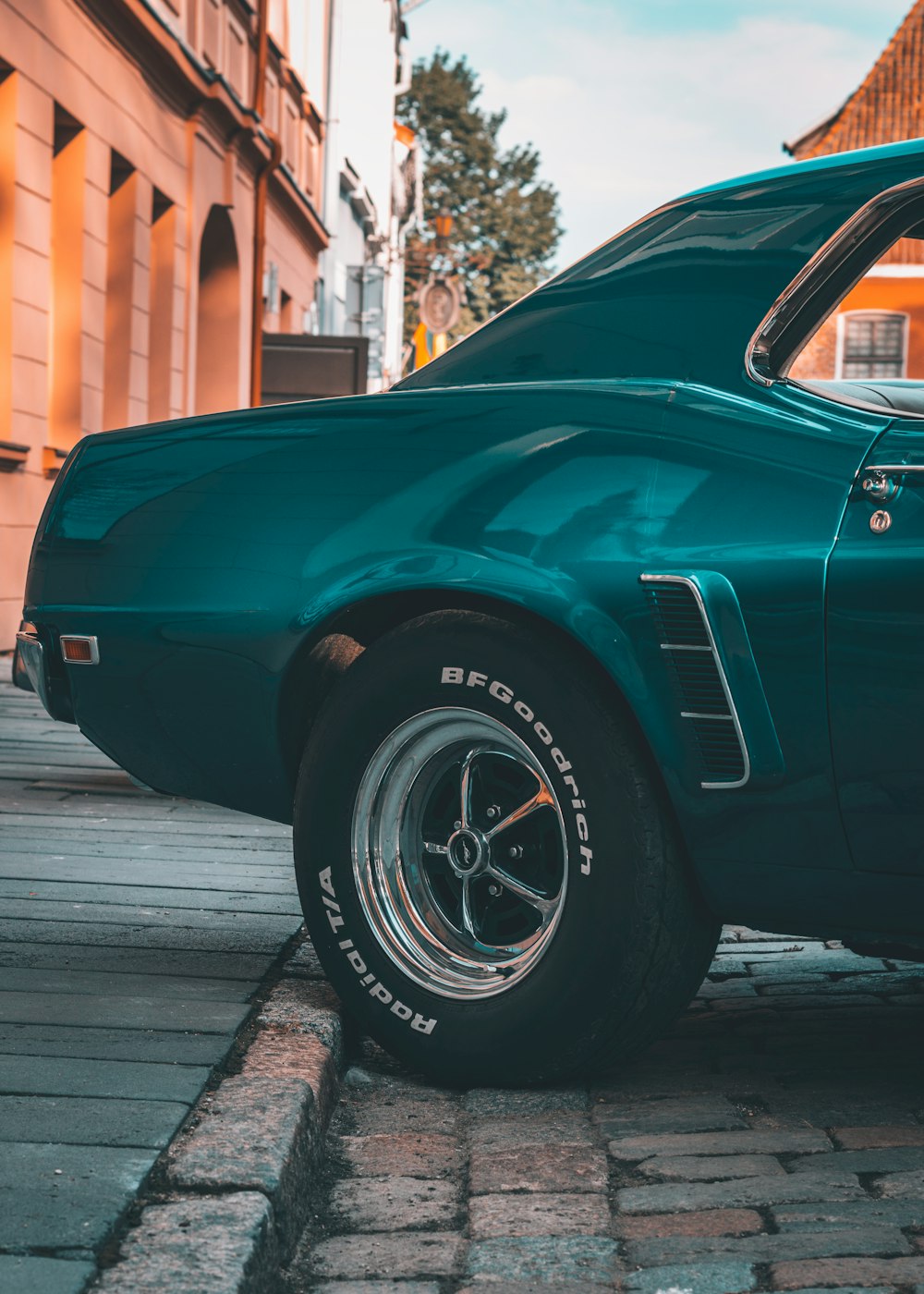 a green car parked on the side of the road