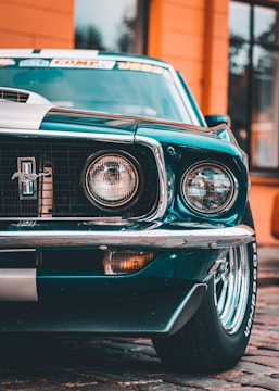 the front end of a green mustang car
