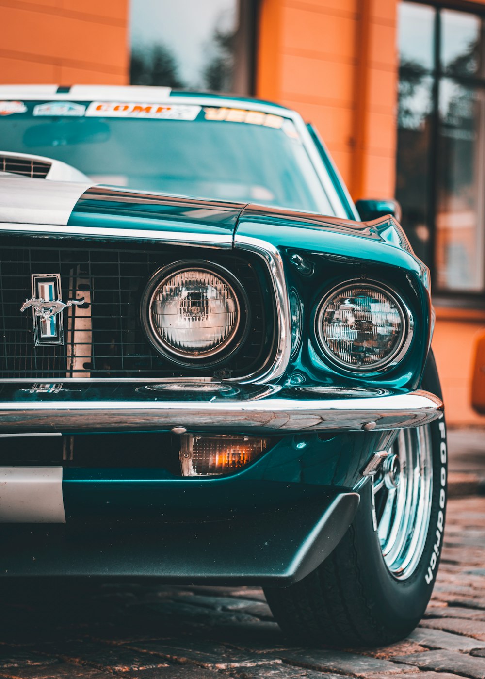 the front end of a green mustang car