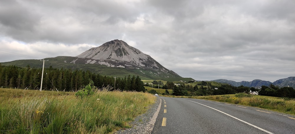 a road with a mountain in the background