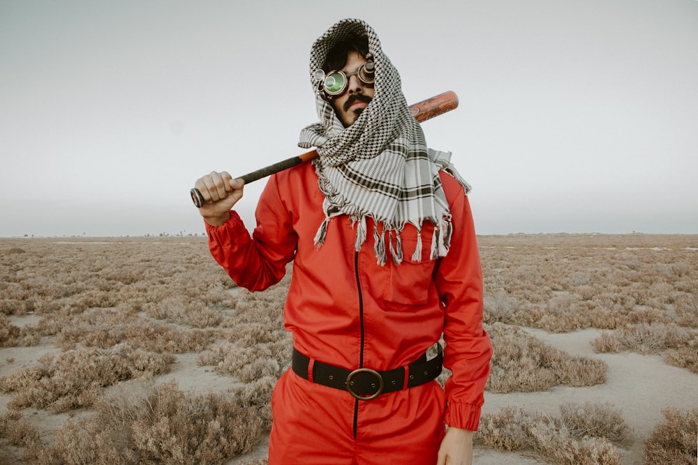 a man in a red outfit holding a baseball bat