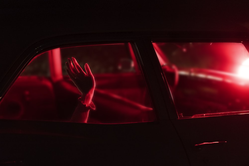 a hand sticking out of a car window