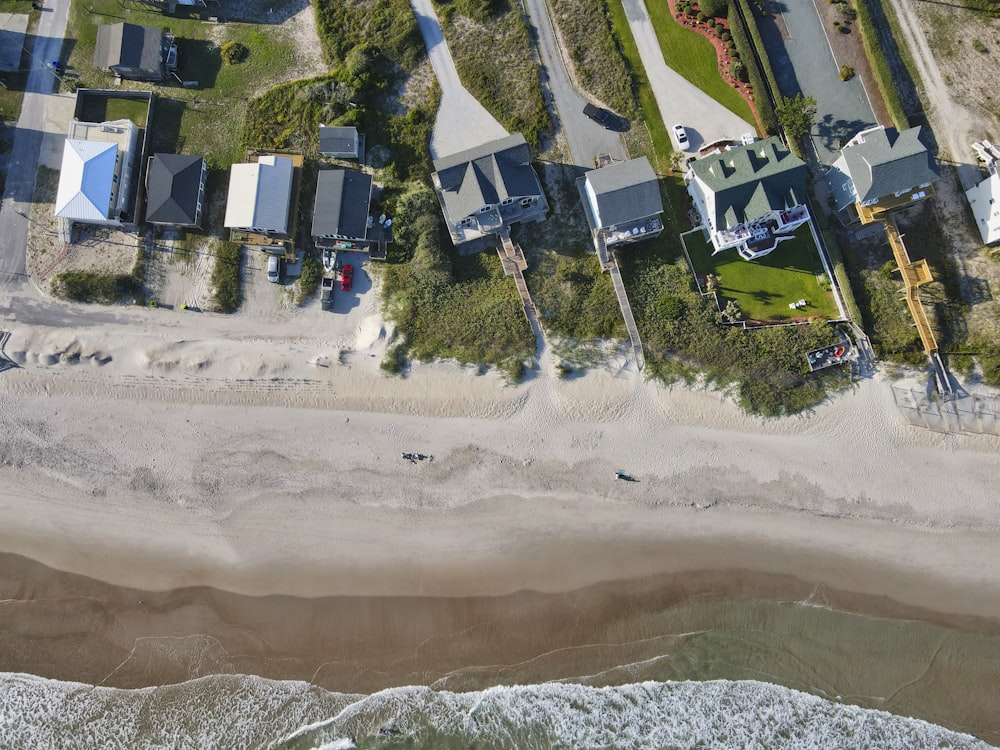 an aerial view of a beach and houses