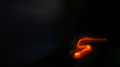 Abstract digital network lines glowing in electric orange against a dark charcoal background.