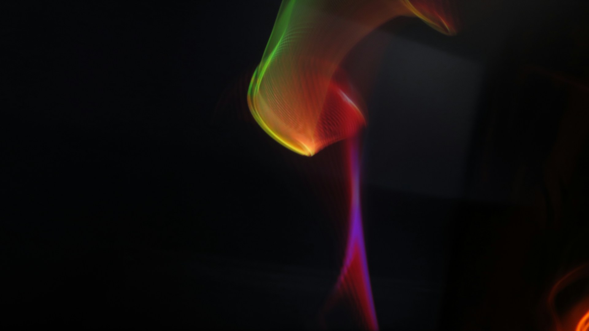 A vibrant swirl of colorful geometric shapes floating smoothly against a dark background, capturing the eye with dynamic motion.