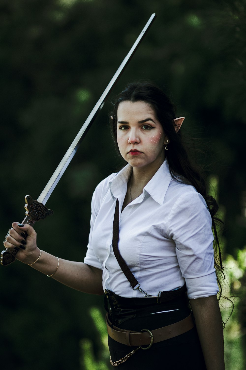 a woman in a white shirt holding a sword