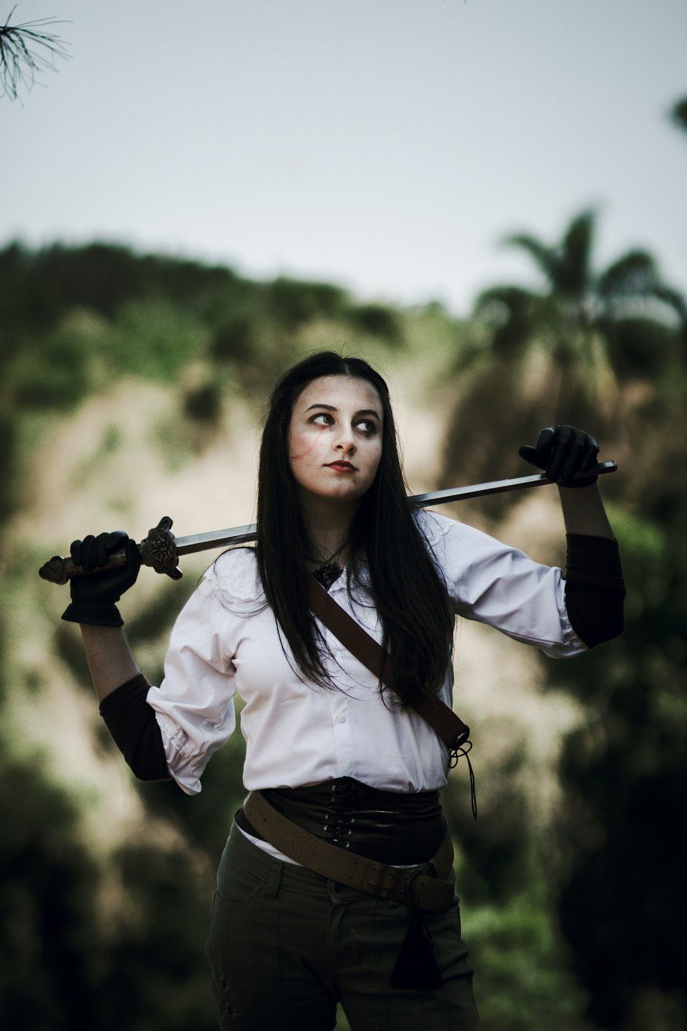 a woman dressed in a pirate costume holding a sword