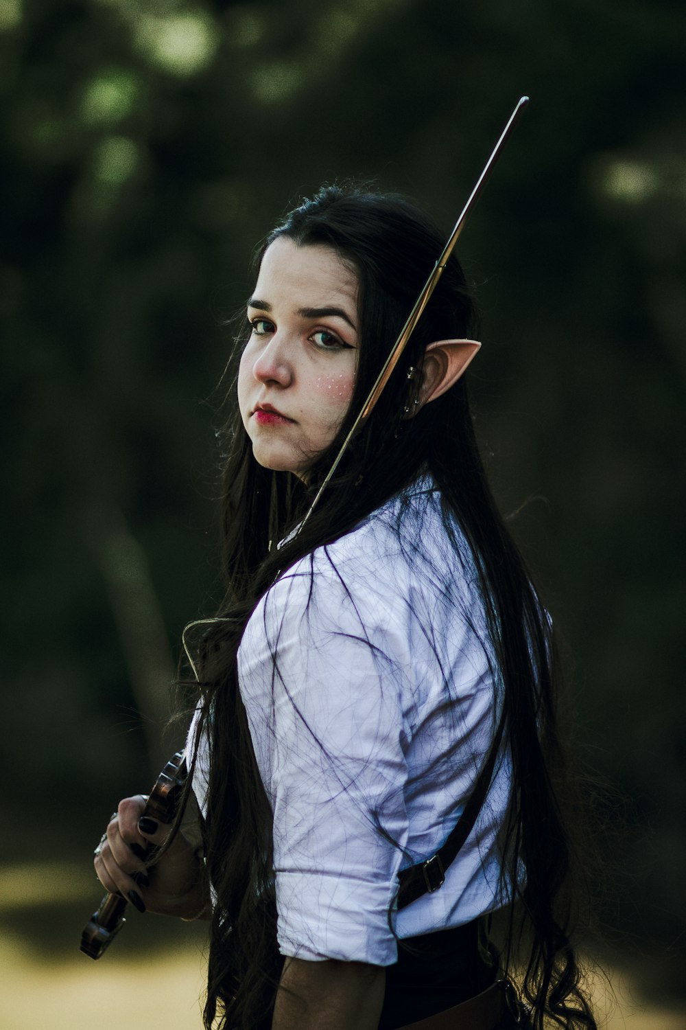 a woman with long hair holding a sword