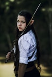 a woman with long hair holding a sword