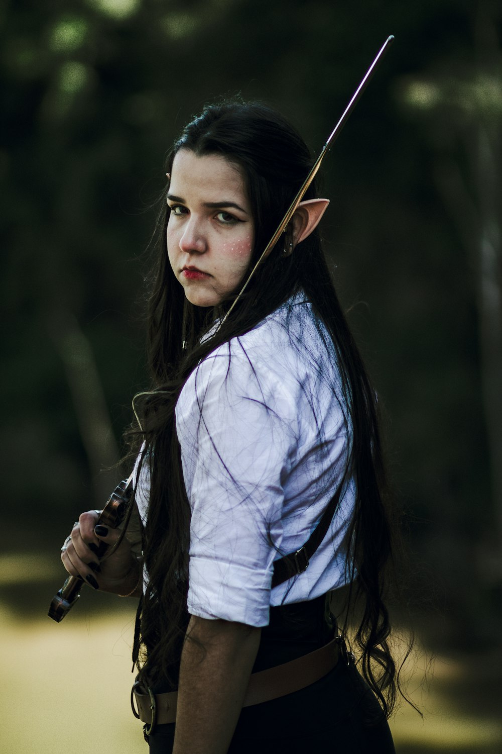 a woman with long hair holding a sword