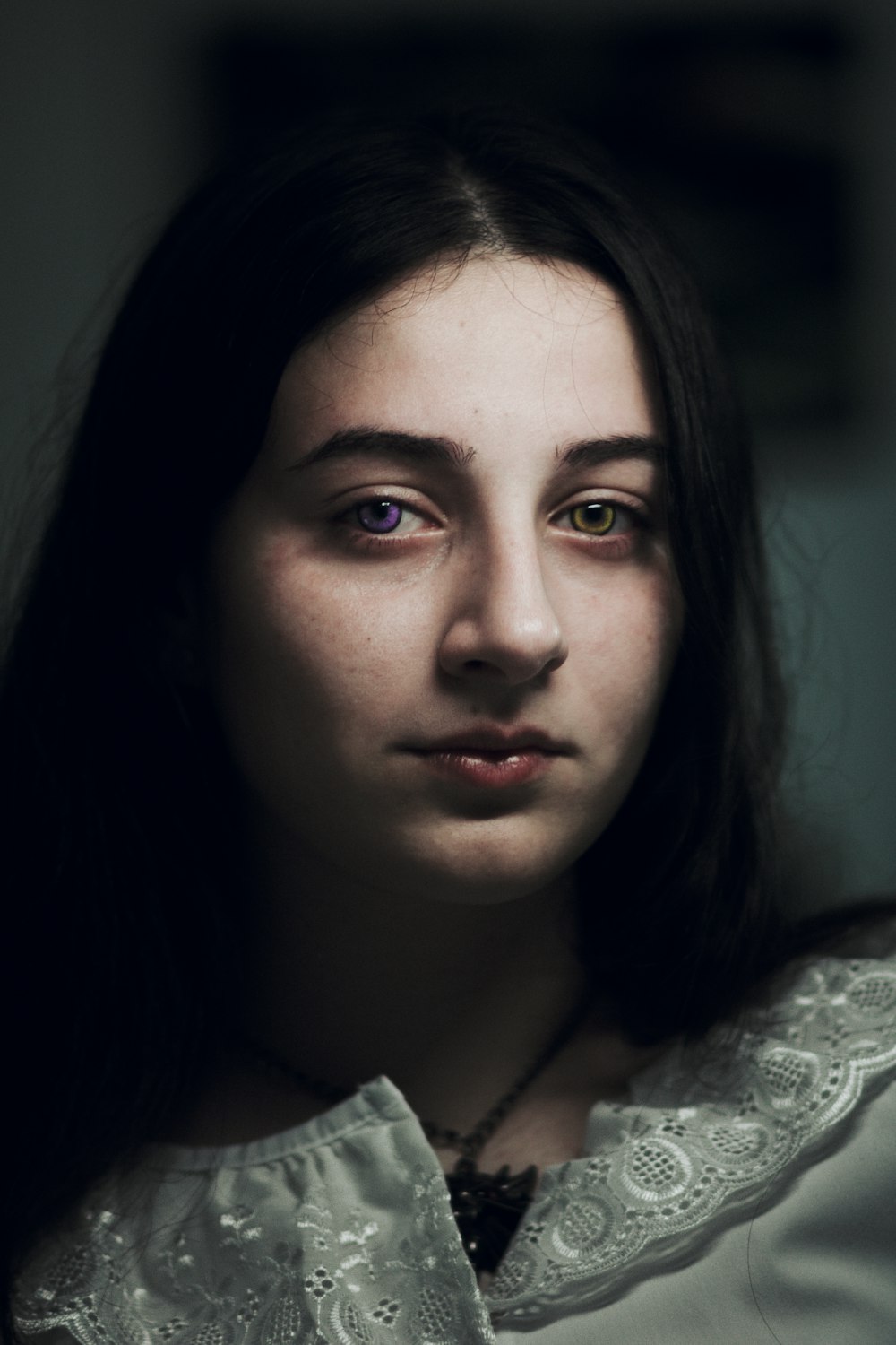 a woman with long dark hair and blue eyes