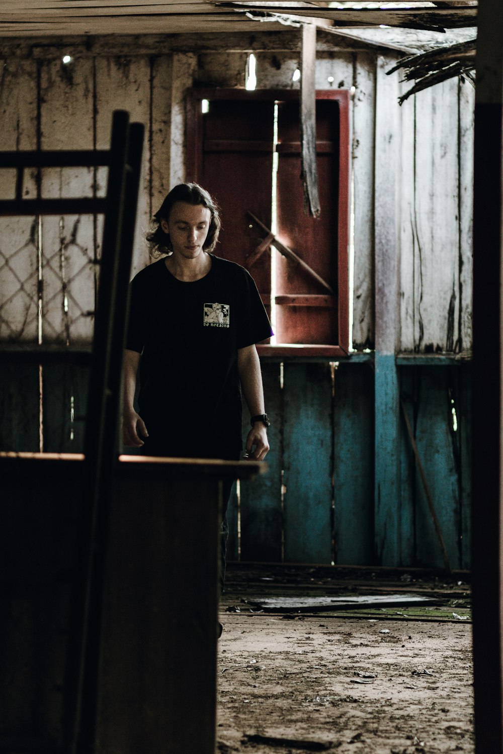 a woman standing in an old run down building