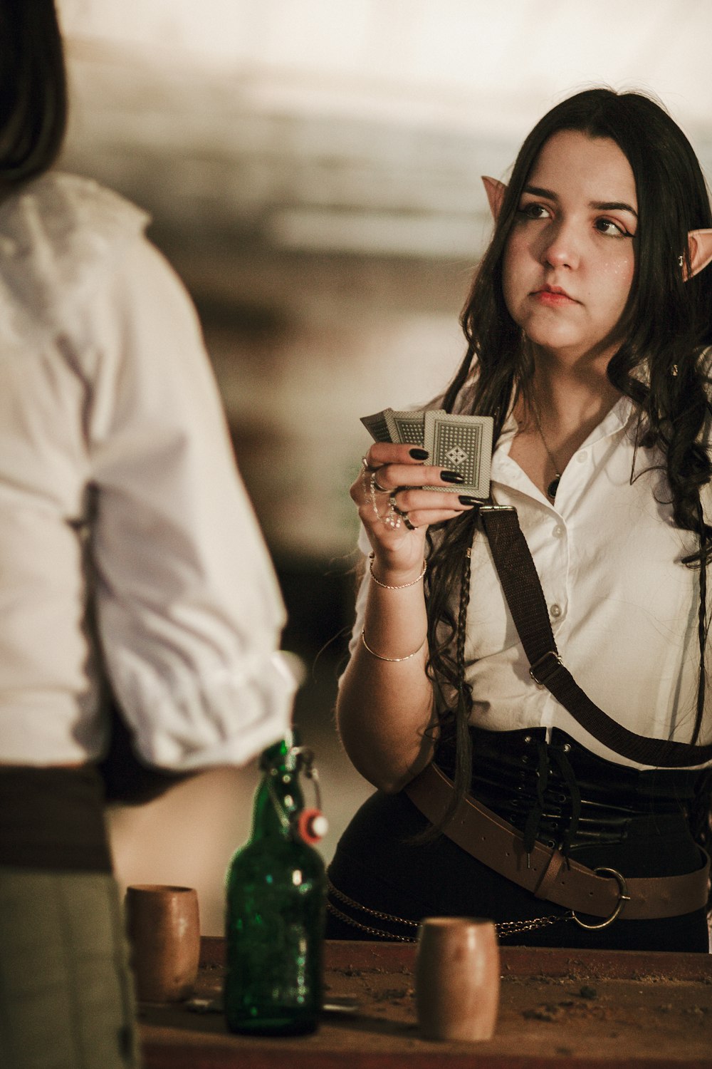 a woman in a white shirt holding a cell phone