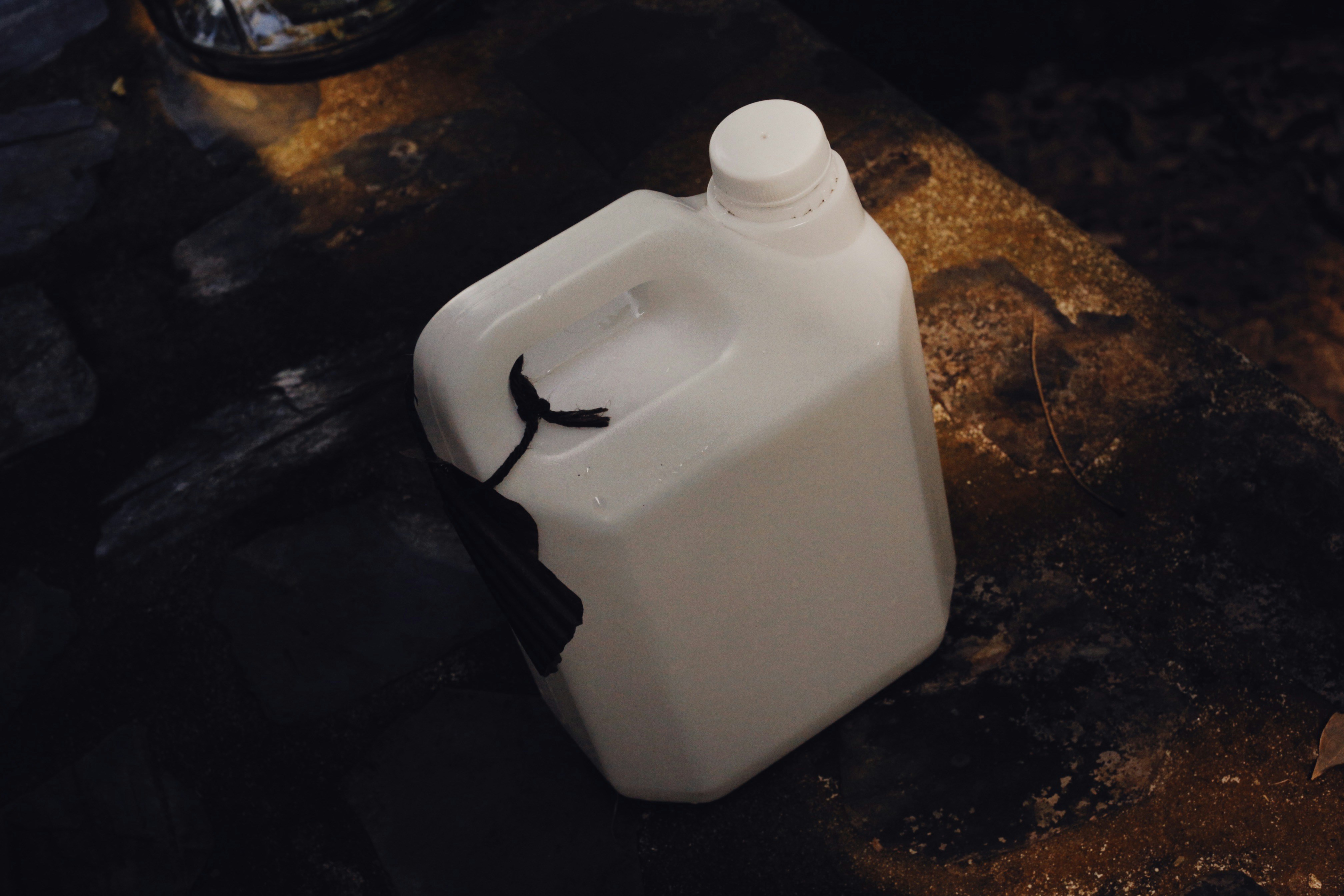 a white jug sitting on top of a wooden table