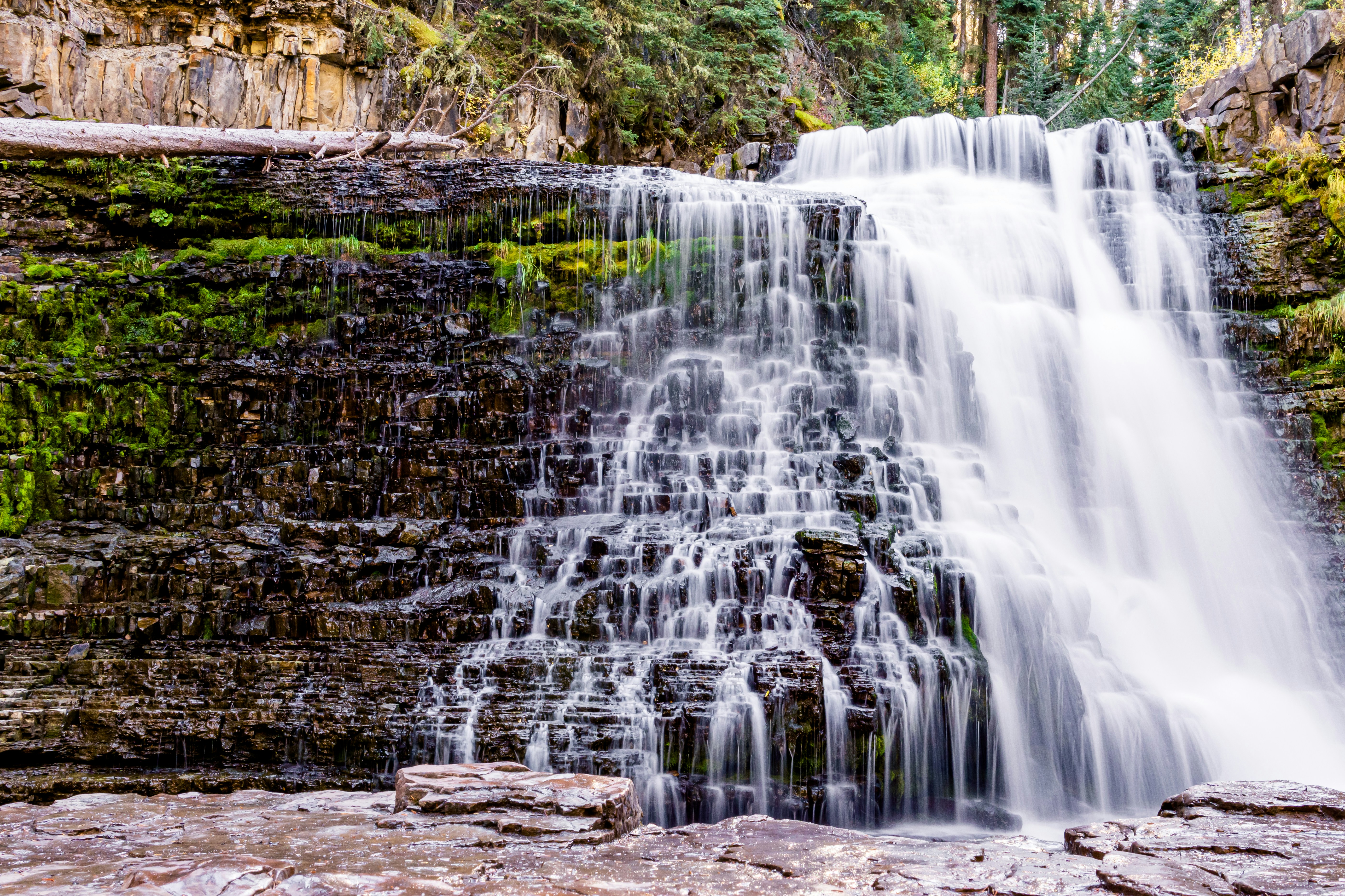 a large waterfall with lots of water coming out of it, Long exposure of Ousel Falls at Big Sky, MT