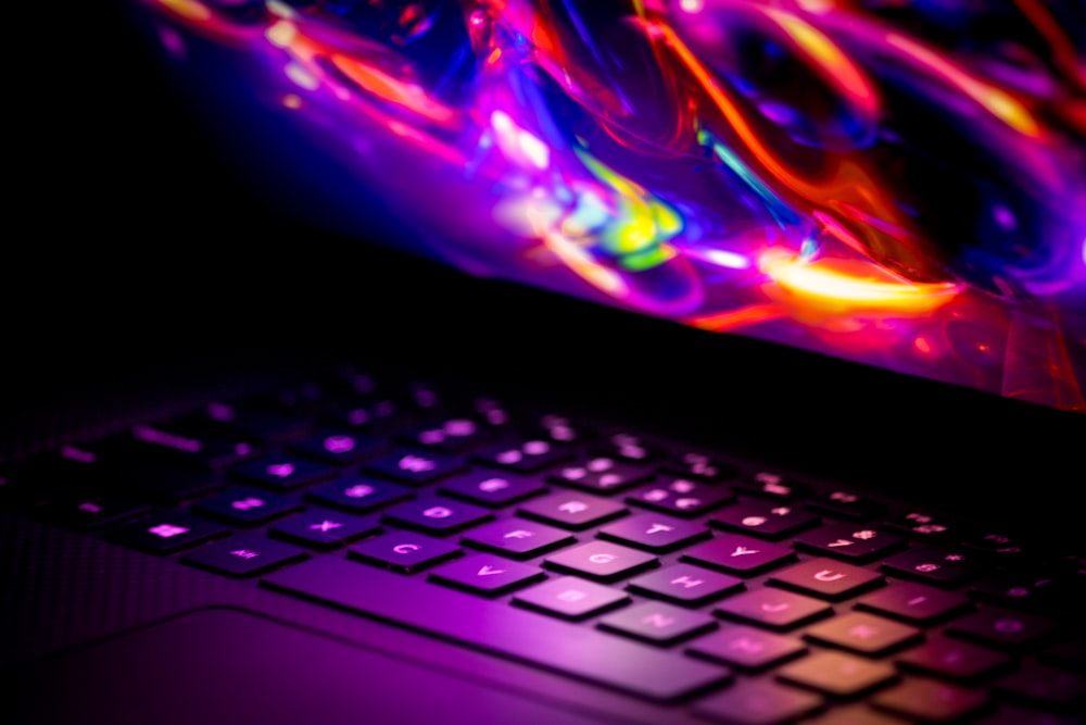 a close up of a laptop with a colorful background