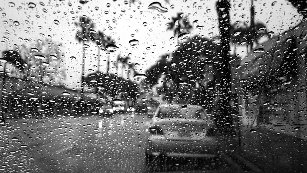 a black and white photo of rain on a window