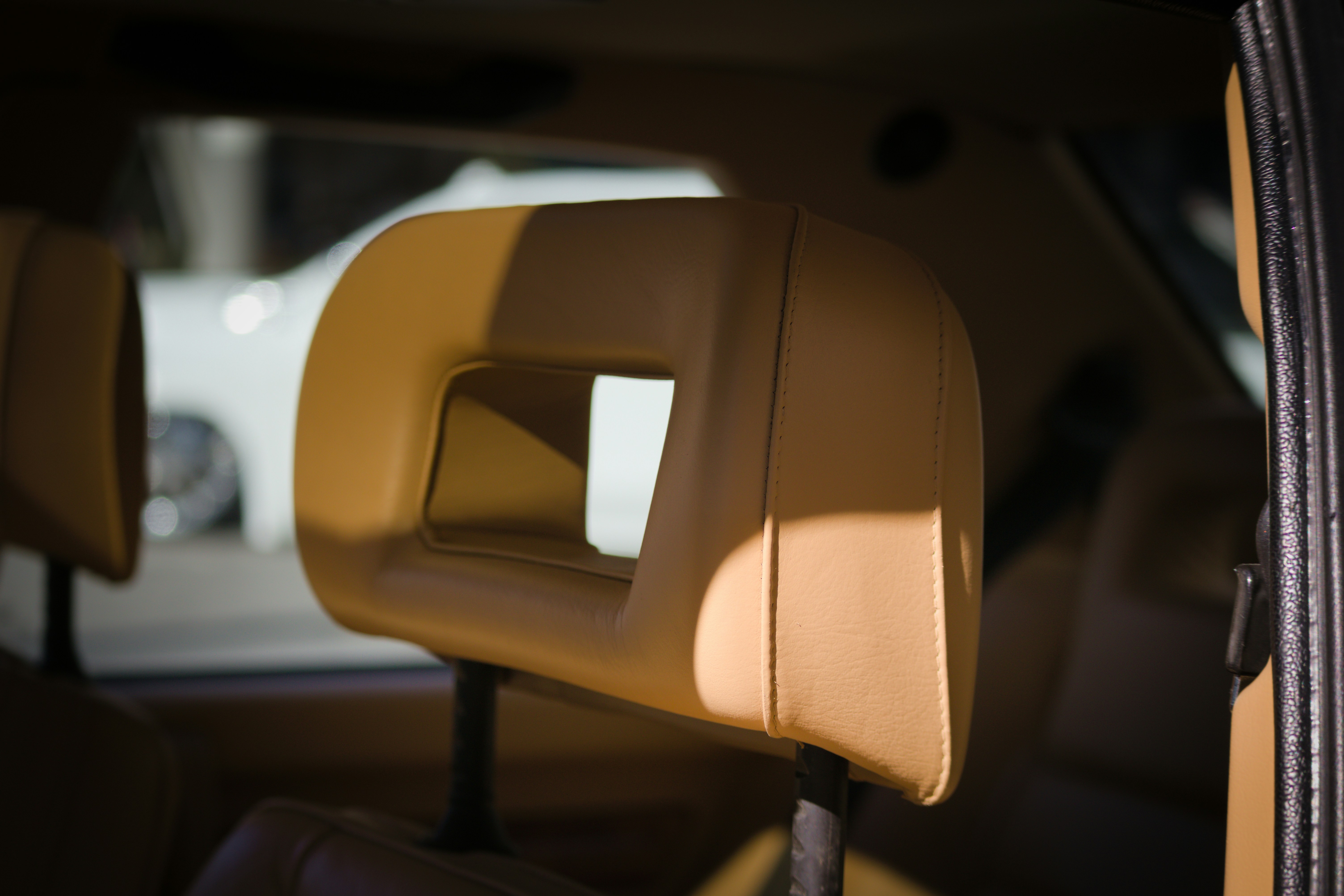 Adjustable car seat with lumbar support dial and multiple position controls - most comfortable rental car for long trip