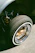 Close-up of a semi truck wheel with a newly installed steering stabilizer shining under sunlight.