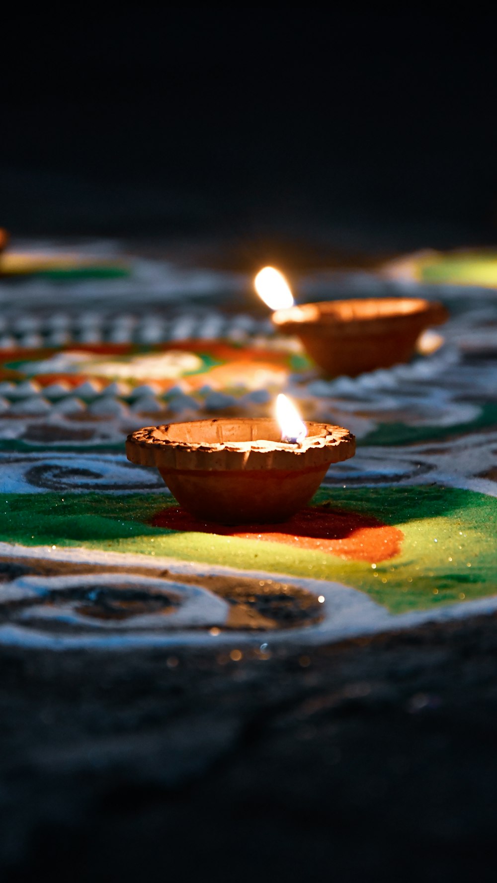 a group of lit candles sitting on top of a table