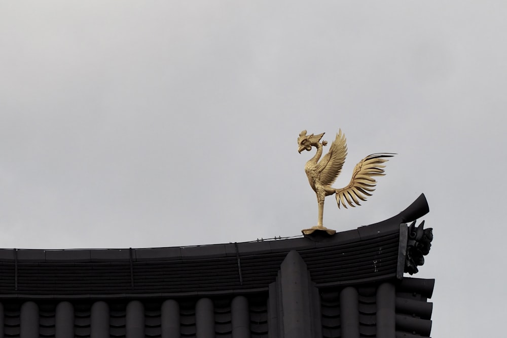 a golden bird statue on top of a building
