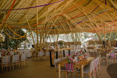a dining area with tables, chairs, and umbrellas