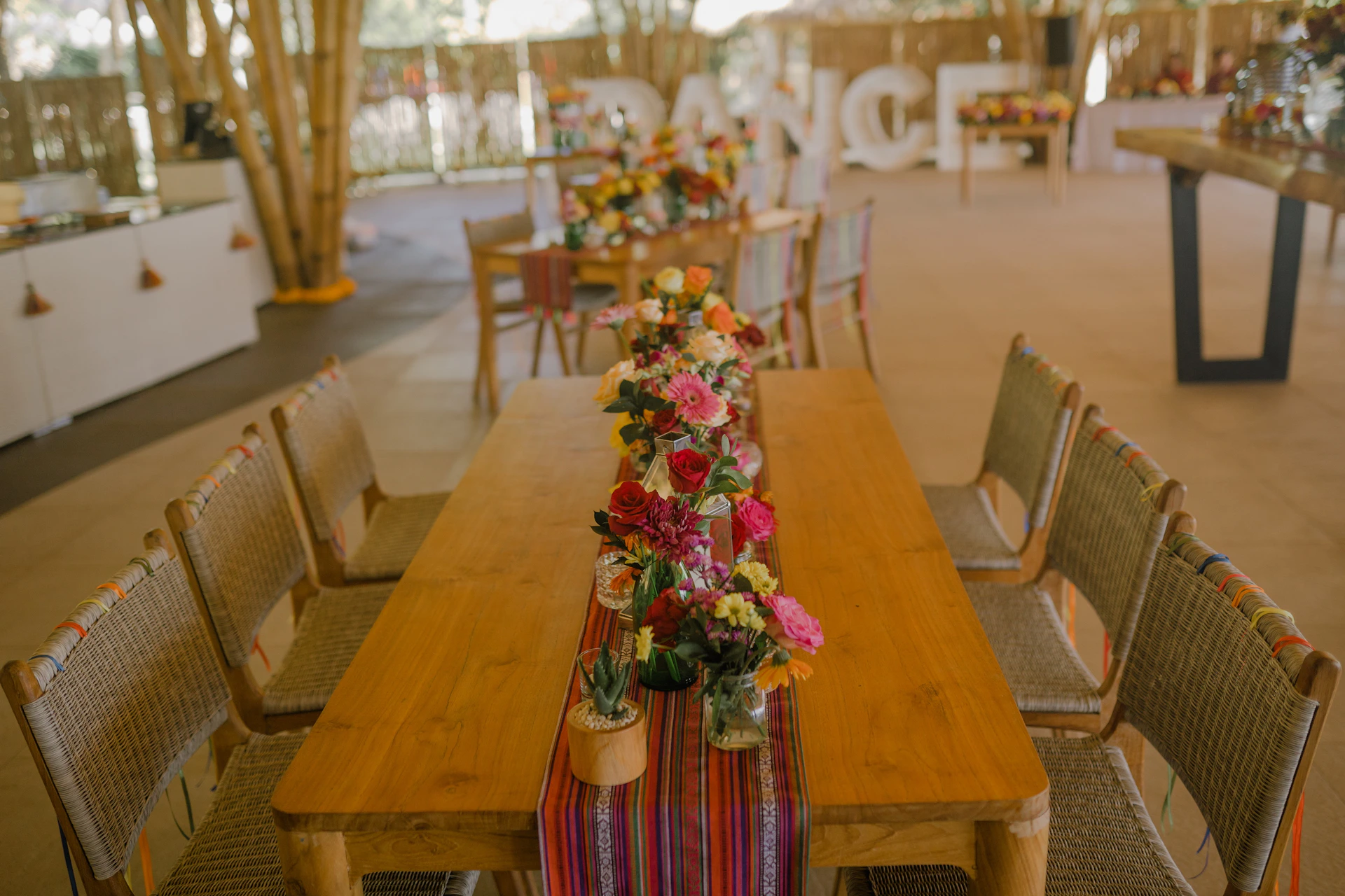 a wooden table topped with lots of flowers