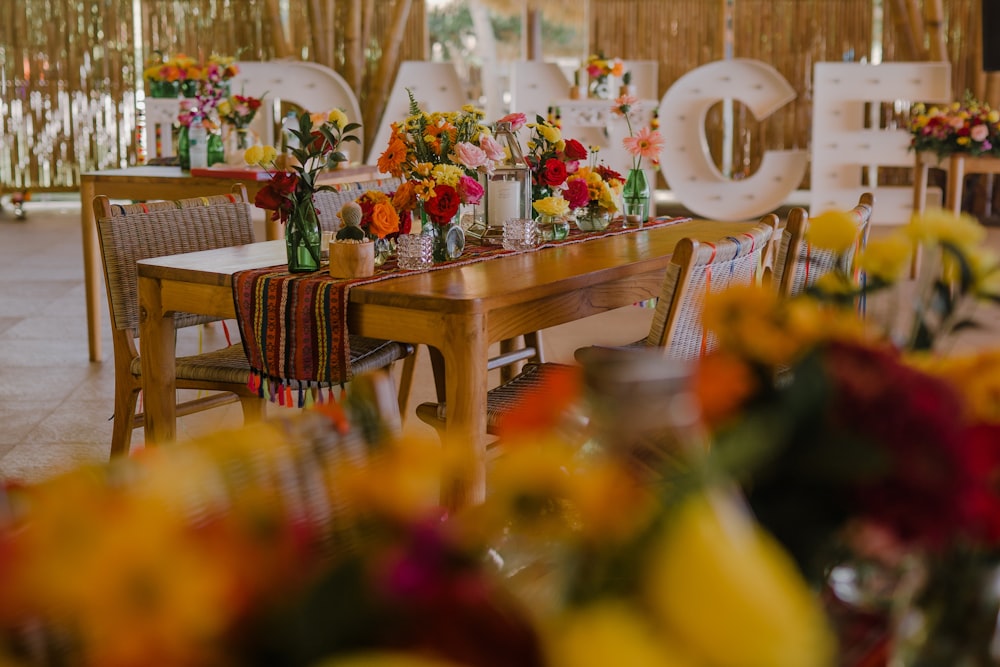 a wooden table topped with lots of flowers