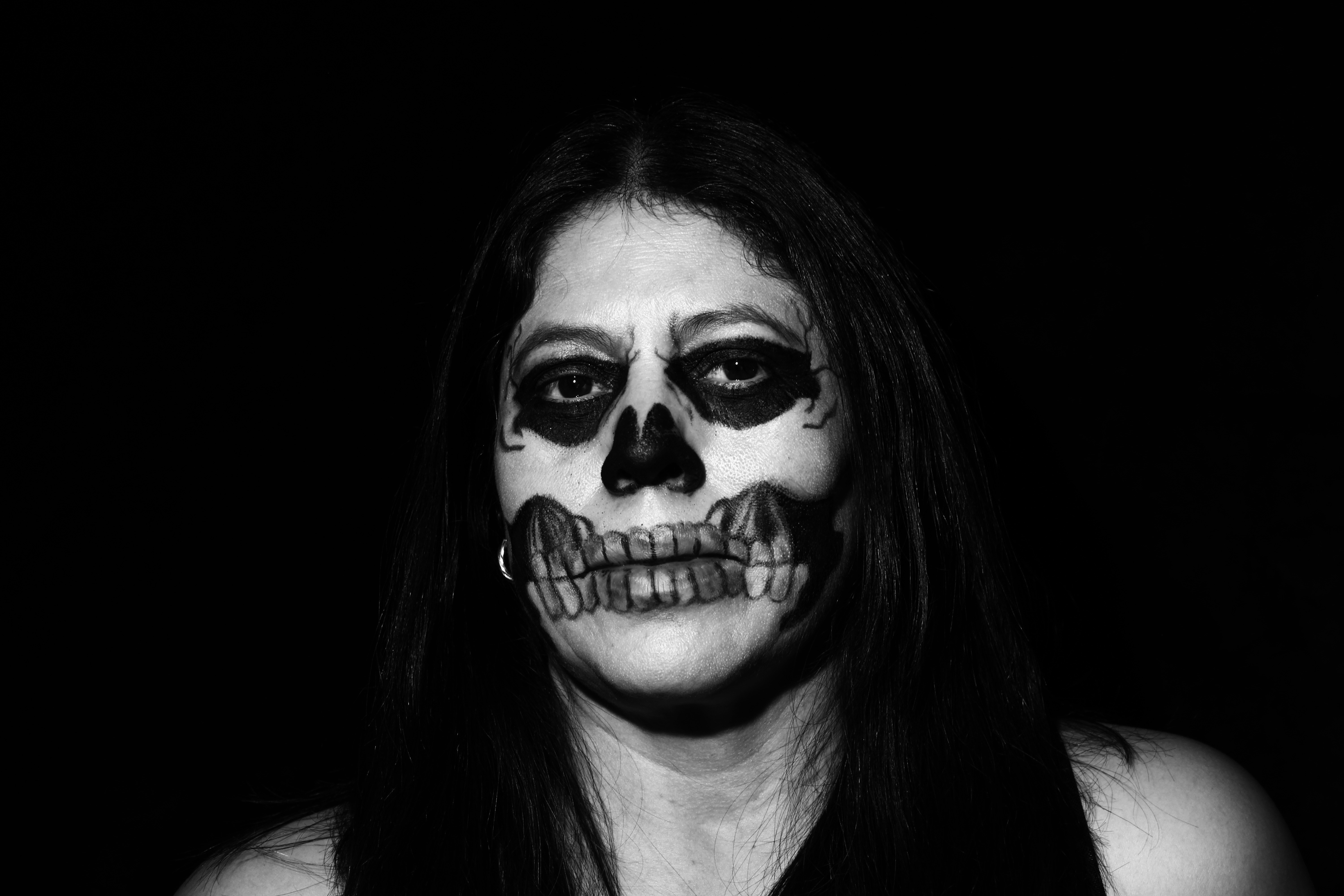 a woman with a skeleton make up on her face