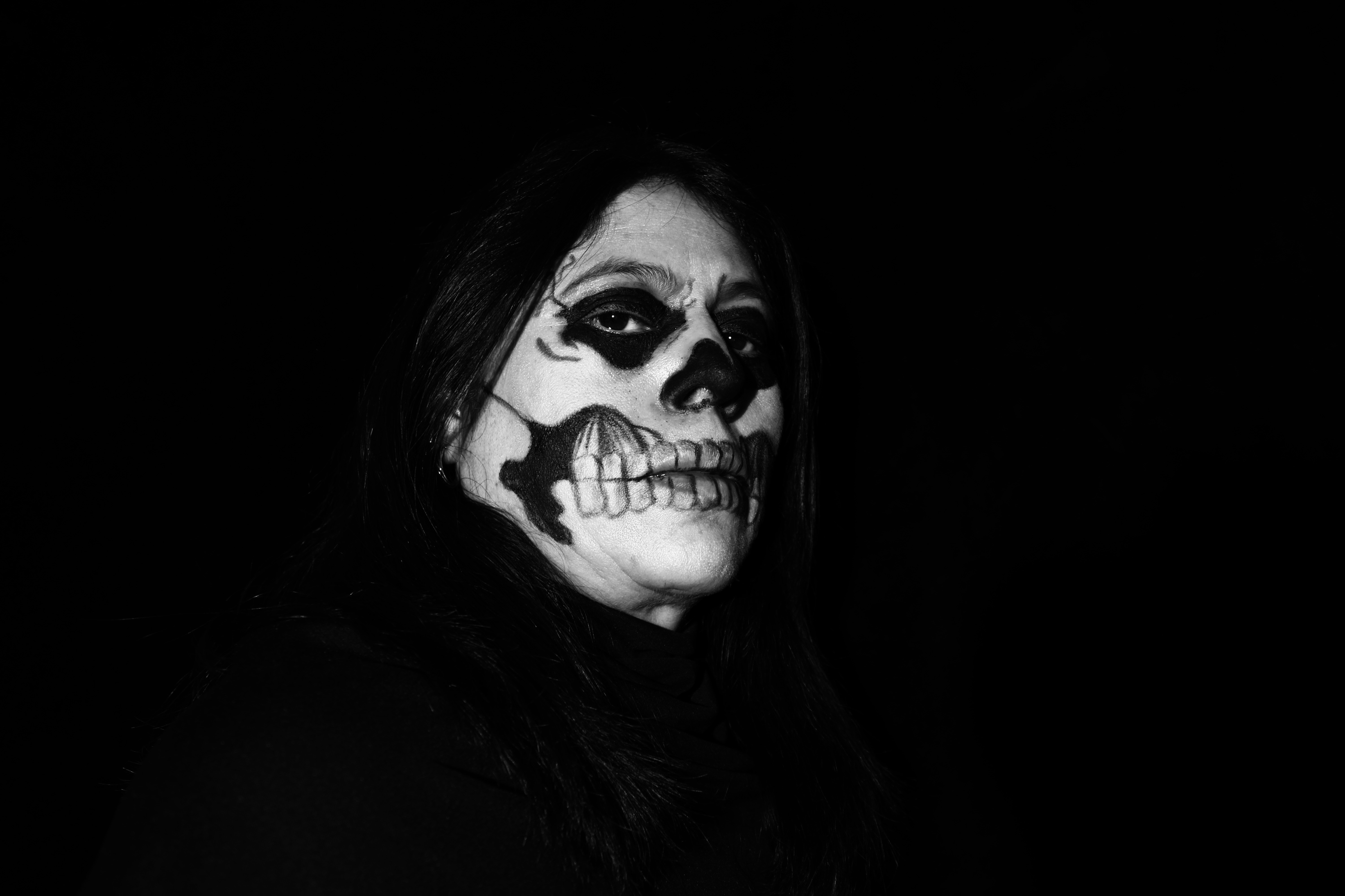 a woman with makeup painted to look like a skeleton