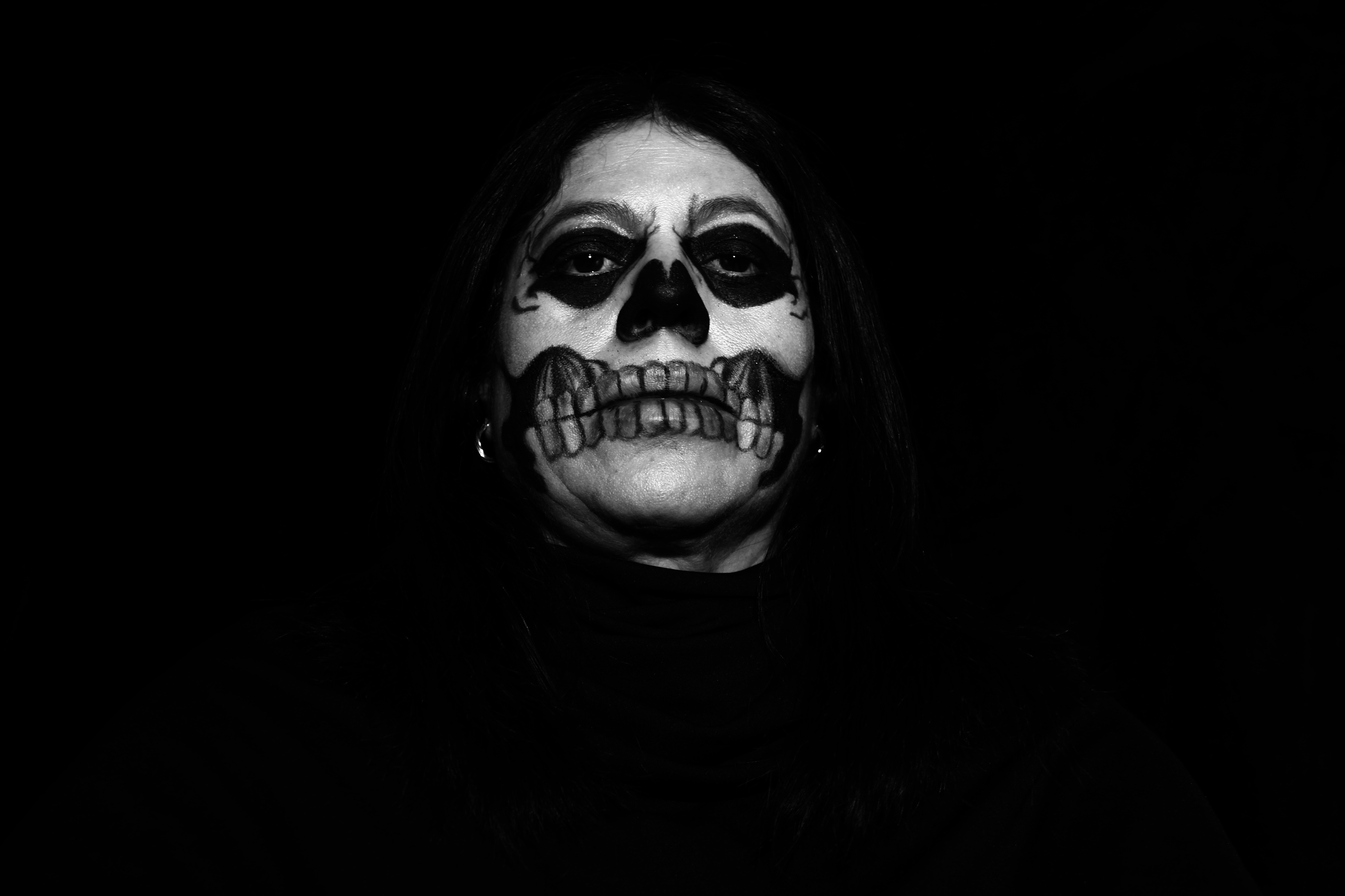 a woman with makeup painted to look like a skeleton