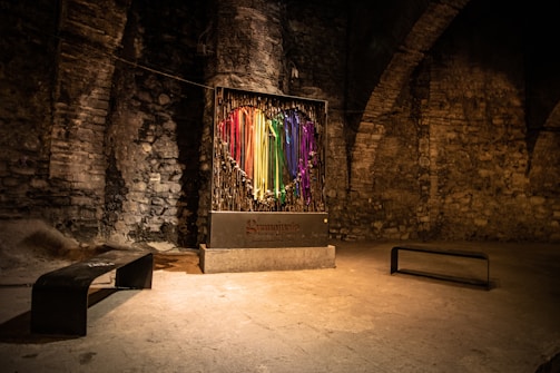 a room with a bench and a display of colored sticks