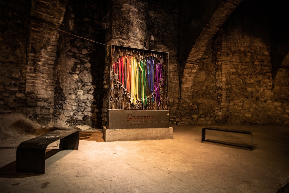 a room with a bench and a display of colored sticks