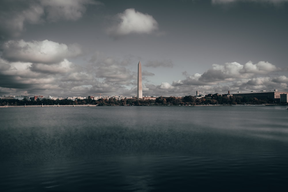 a large body of water with a tall building in the background