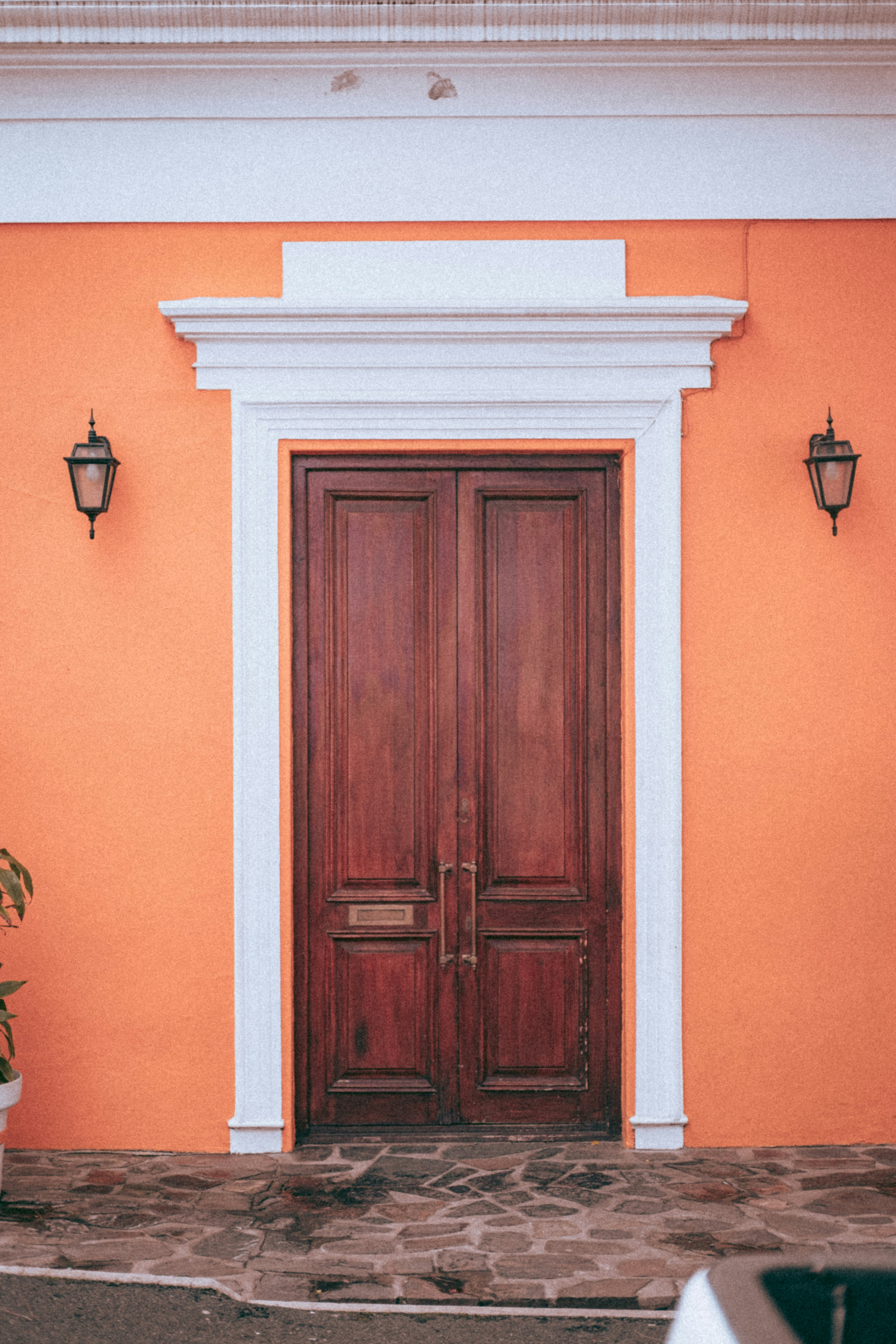 a red and white building with two wooden doors
