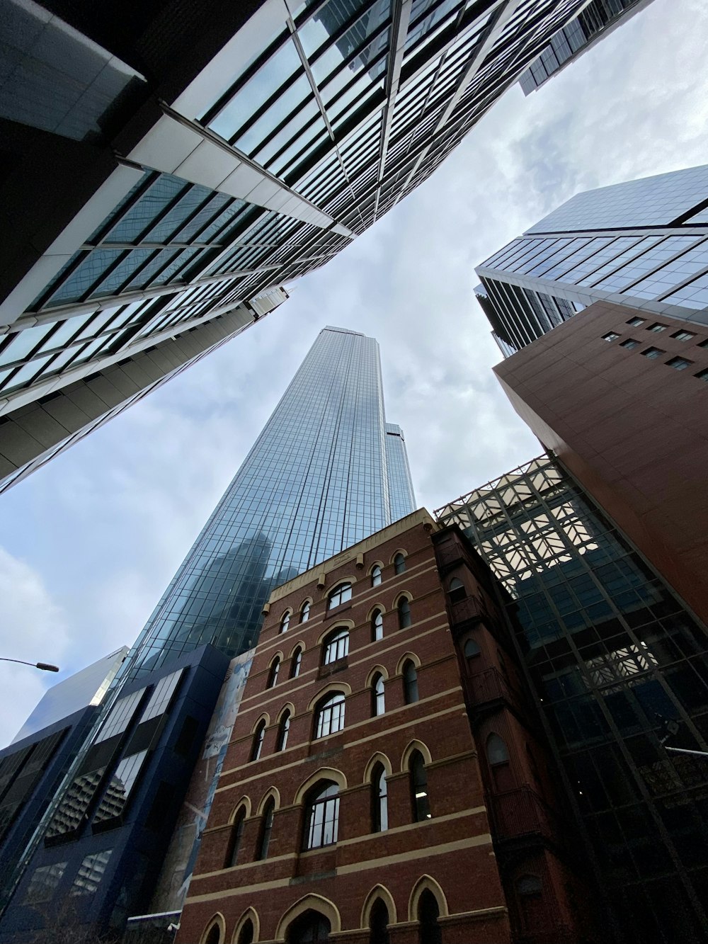 looking up at tall buildings in a city