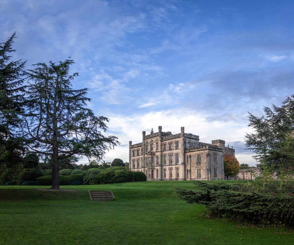 a large building sitting on top of a lush green field