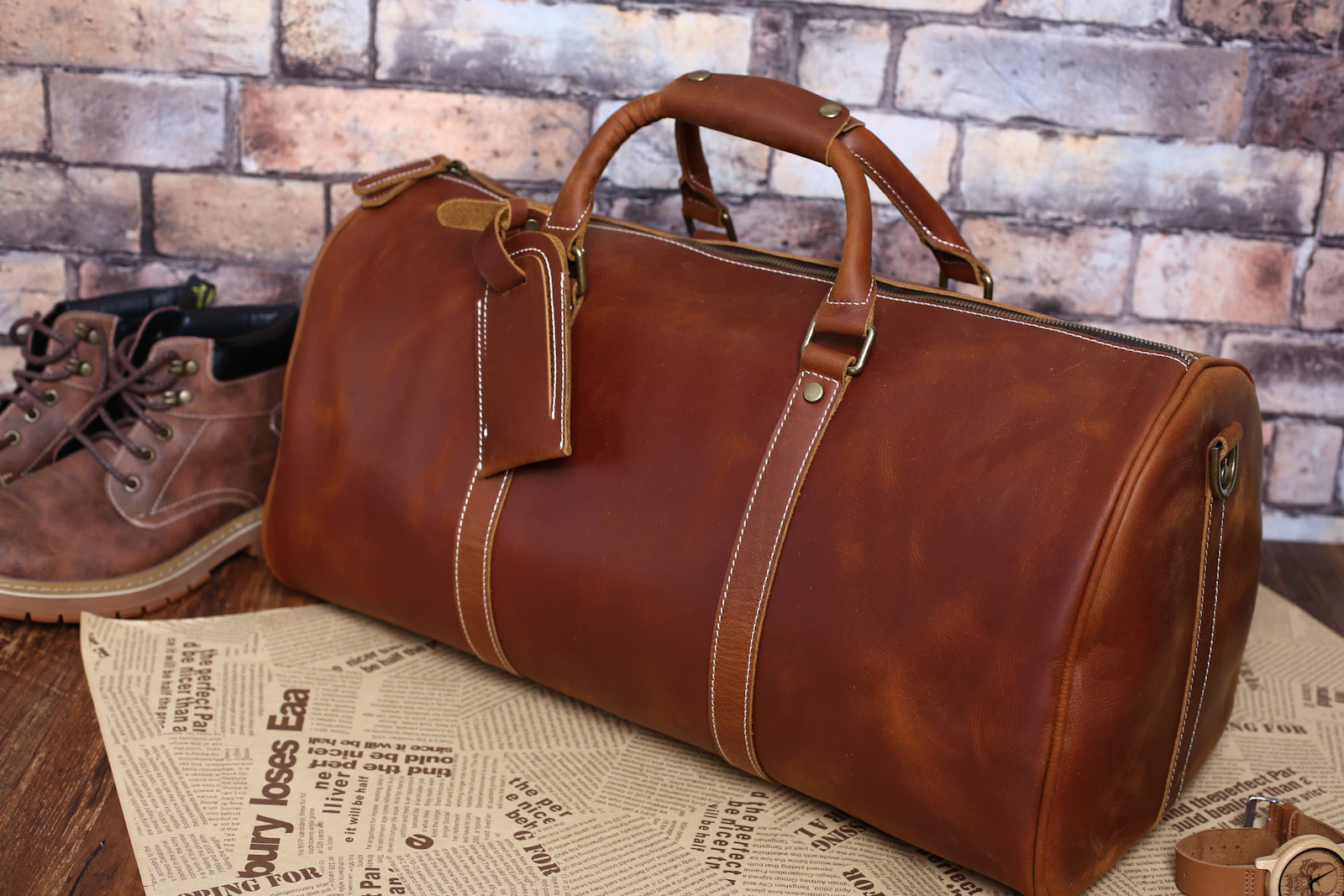 Brown leather duffel bag on table