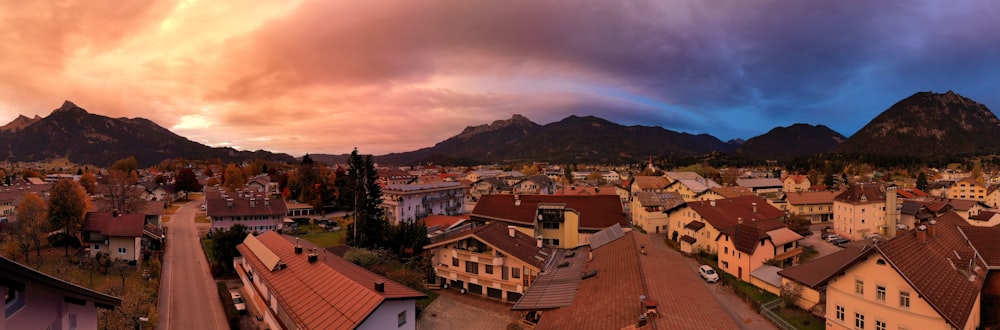 an aerial view of a town with mountains in the background