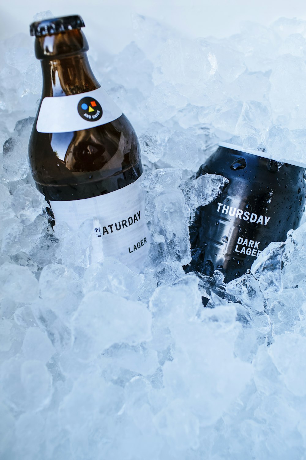 a bottle of beer sitting on top of ice
